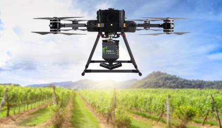 Seed Sowing:  Drone Flying over an orchard sowing seeds with seed attachment.